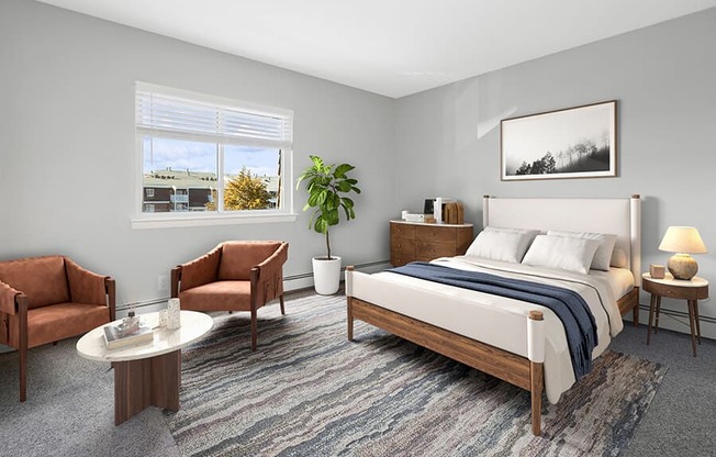 Model Bedroom with Carpet and Window View at Stone Ends Apartments in Stoughton, MA.