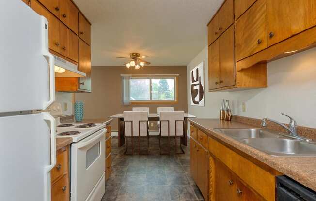 the kitchen and dining area of a rental house. Fargo, ND Country Club Apartments.