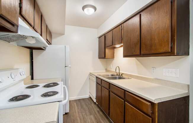 a kitchen with wooden cabinets and white appliances