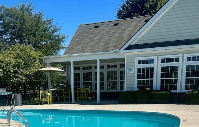 a swimming pool with a house in the background at Traditions at Slate Ridge, Reynoldsburg