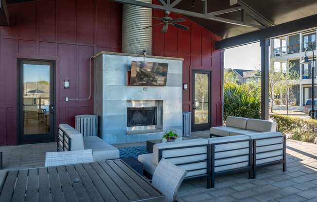 a living room with a fireplace and a table and chairs