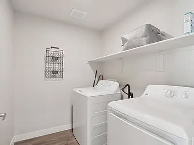 A white washer and dryer in a small laundry room.