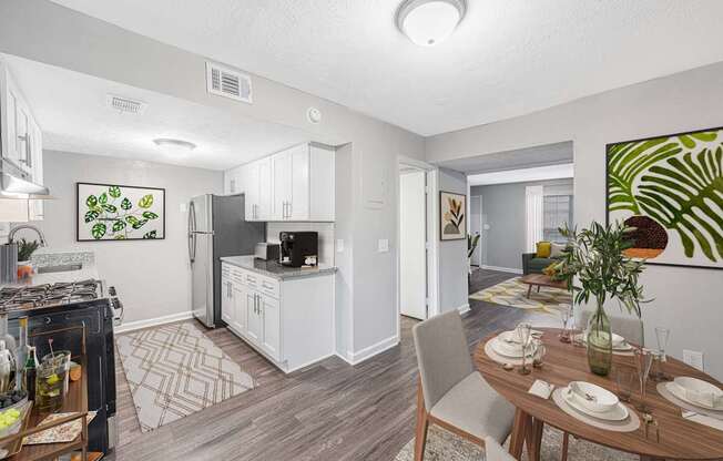 an open kitchen and living room with a dining table