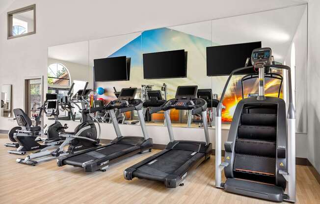 A gym with treadmills and exercise bikes.