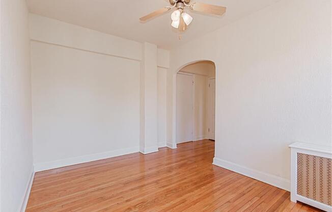 vacant living area with hardwood flooring and ceiling fan at parkside apartments in washington dc