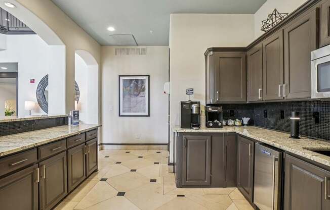 A kitchen with brown cabinets and a black and white checkered floor.