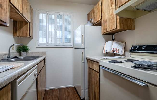 a kitchen with a stove refrigerator and sink