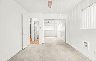 a bedroom with a bed and a ceiling fan