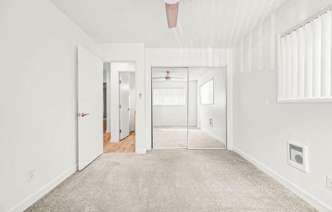 a bedroom with a bed and a ceiling fan