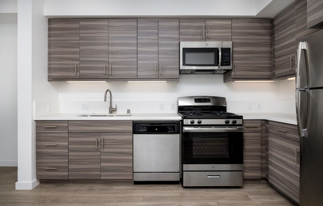 a kitchen with stainless steel appliances and wooden cabinets