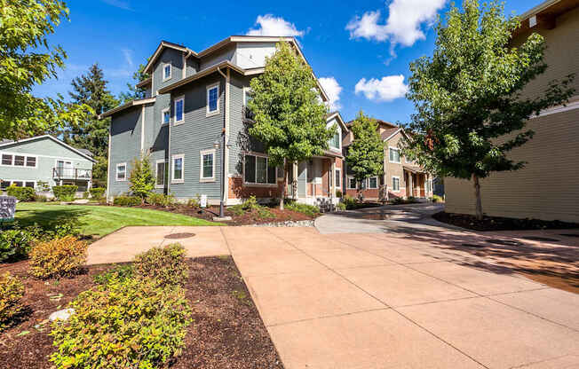 A sunny day at a residential area with houses and a clear blue sky.