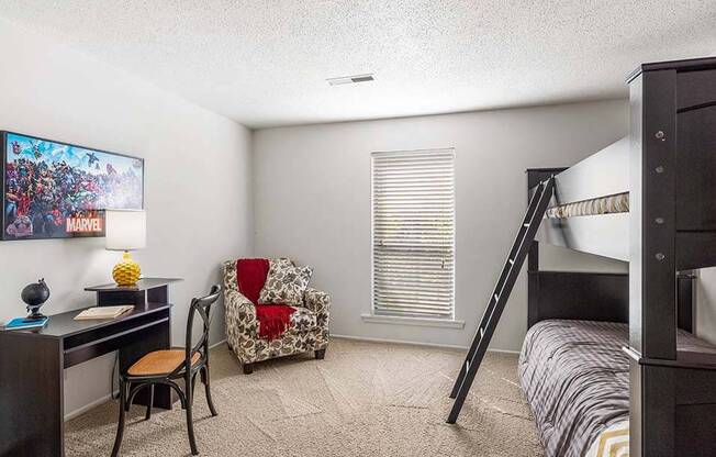 a bedroom with a bunk bed and a desk