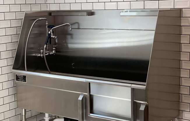 Forever Stainless Steel Animal Washer  with Sink Head and White Tile Walls