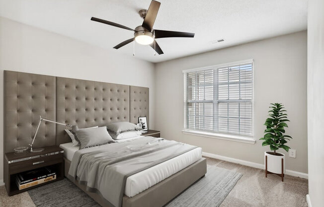 Model bedroom with ceiling fan at Retreat at Stonecrest Apartments