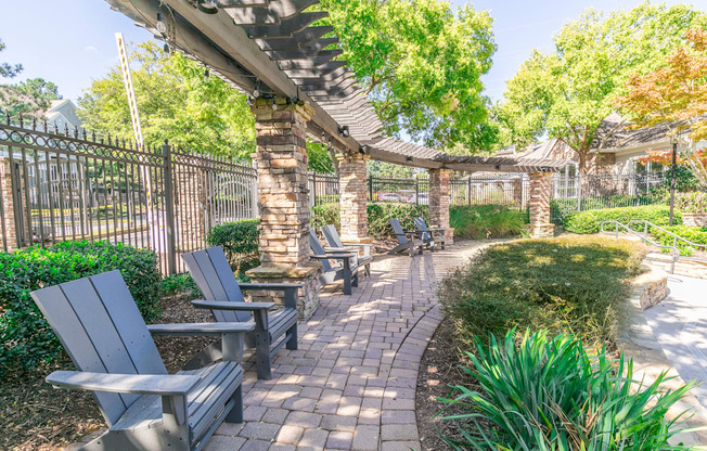 a patio with benches and a fence and trees at Deerfield Village, Alpharetta, GA, 30004