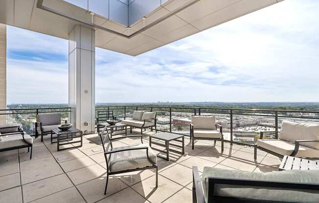 outdoor sitting area with patio furniture and a view of the city