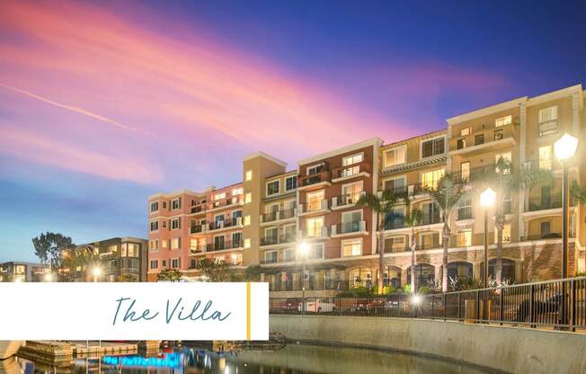 The image shows a building named The Villa with a beautiful view of the waterfront at dusk at Marina Harbor, California, 90292