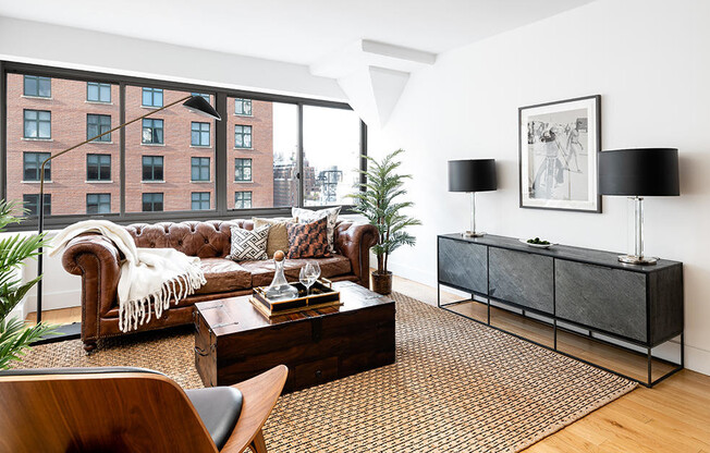 Bright and airy living room with wood floors and unique building details in Upper East Side