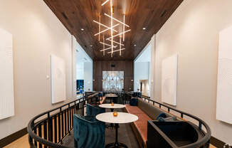 a large lobby with tables and chairs and a large chandelier at Preston Ridge, Cary, NC