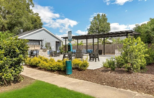 a patio with tables and chairs and a pergola