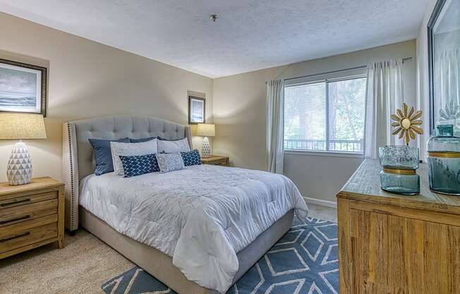 One Bedroom Apartments in Vinings, GA - Wynnwood Vinings - Furnished Bedroom with Plush Carpet Flooring and a Window