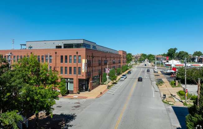 an aerial view of a city street with a brick building