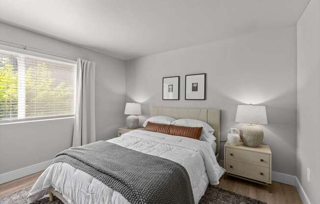 a bedroom with a bed and a large window