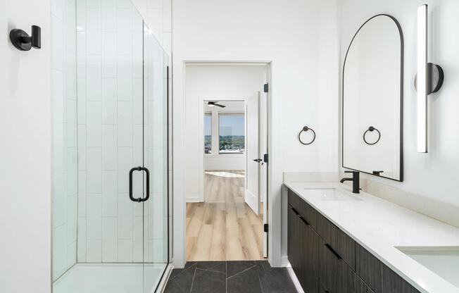 A sleek primary bath at Modera Nations in Nashville showcases spa-inspired design with the option to choose light or dark finishes to suit your style.