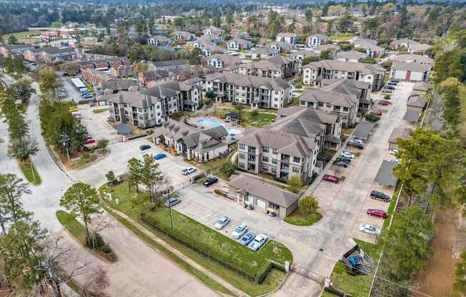 A bird's eye view of a residential area with houses and cars.