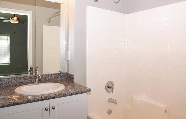 a room with a sink and a mirror