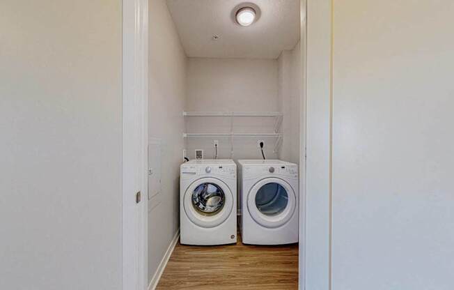 A laundry room with two washing machines.