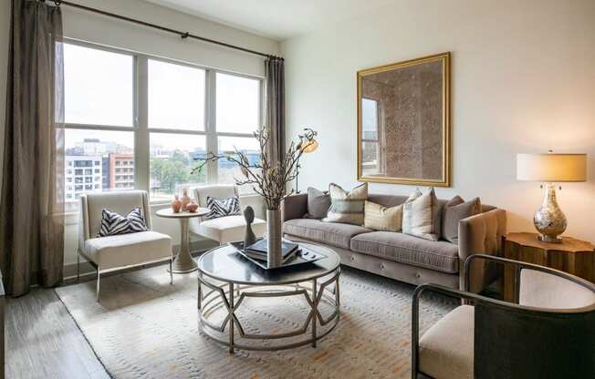 Arabelle Perimeter Luxury Apartments in Atlanta, GA 30328 photo of a living room with a large window and a couch