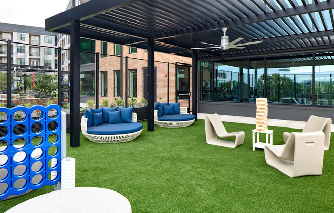 A patio with a white table and blue couches.