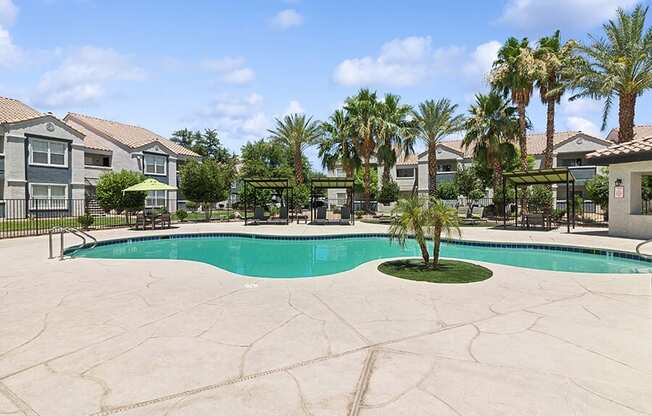 Community Swimming Pool with Pool Furniture at Monterra Apartments located in Las Vegas, NV.