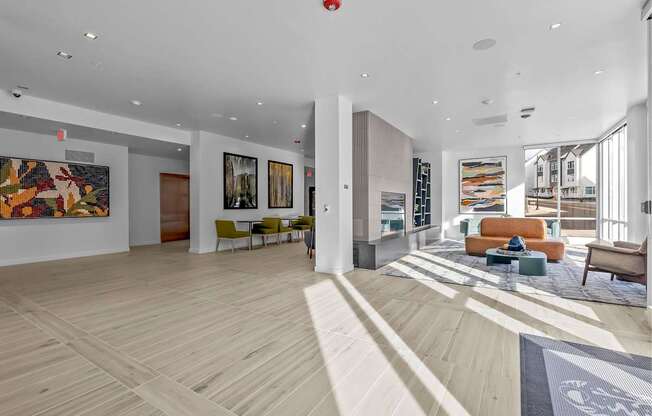 A spacious living room with a hardwood floor and a large rug.