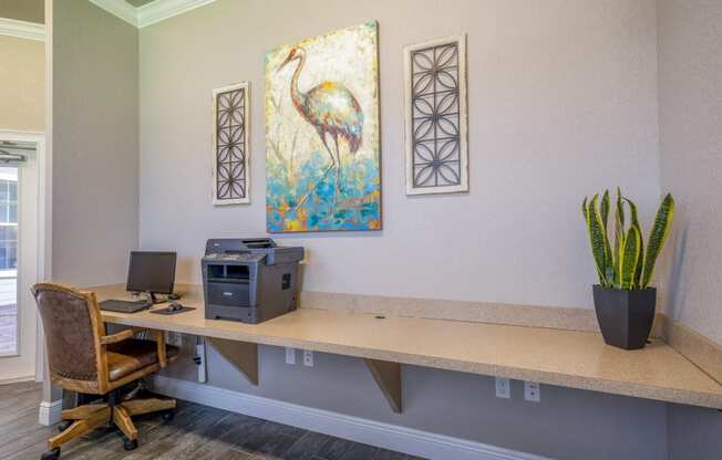 a business center with a desk and a painting on the wall