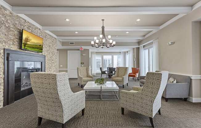 a lobby with couches and chairs and a fireplace