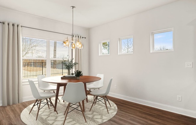 a dining room with a table and chairs and a window
