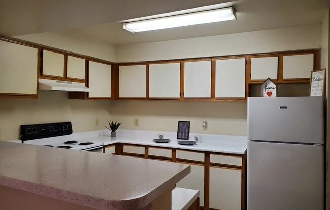 a kitchen with white cabinets and a white counter top at GABLE HILLS Apartments, TULSA, OK, 74127