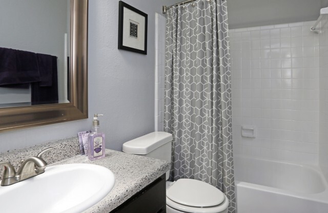Duncanville TX Apartments - Cozy Bathroom with Modern Interiors and Shower and Tub Combo