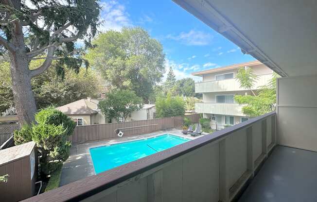 a view of the pool from the balcony of an apartment