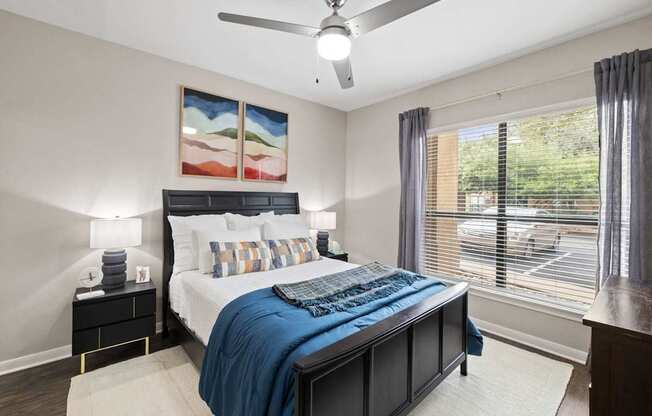 a bedroom with a bed and a ceiling fan