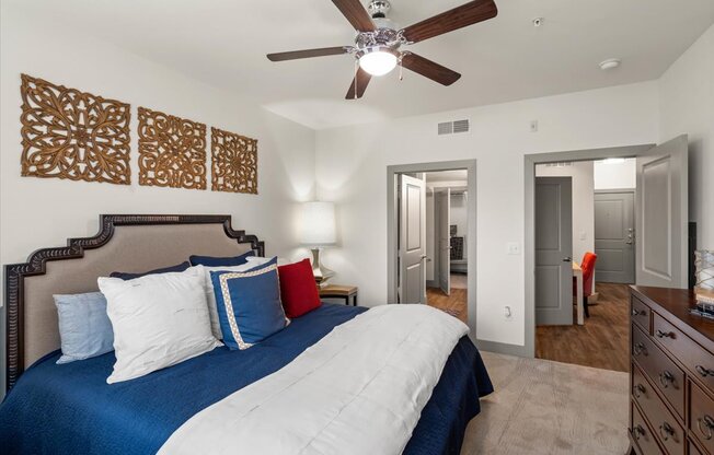 a bedroom with a large bed and a ceiling fan