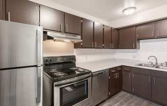 a kitchen with a stove top oven next to a refrigerator