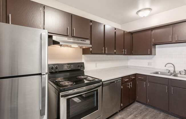 a kitchen with a stove top oven next to a refrigerator