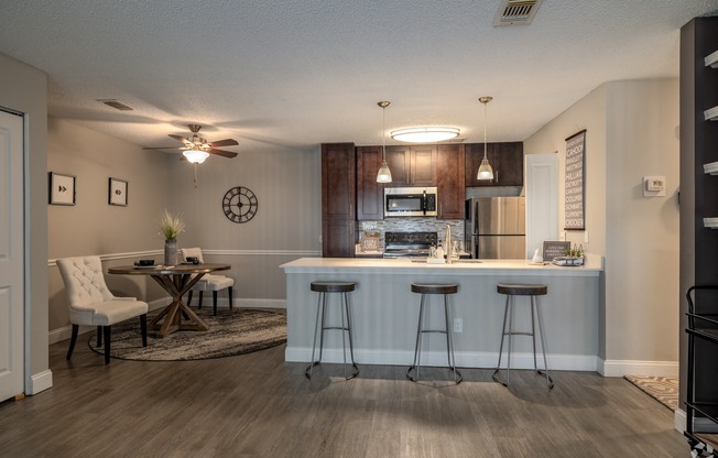 a kitchen with a bar and a surfboard on the wall