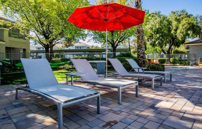 Octave Apartments in Las Vegas, Nevada Poolside Lounge Chairs and Umbrella at Octave Apartments, Nevada, 89123