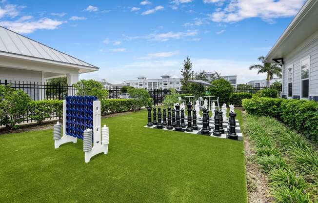 a large outdoor chess set on the lawn