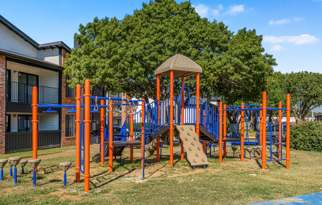 A playground with a slide, swings, and a climbing frame.