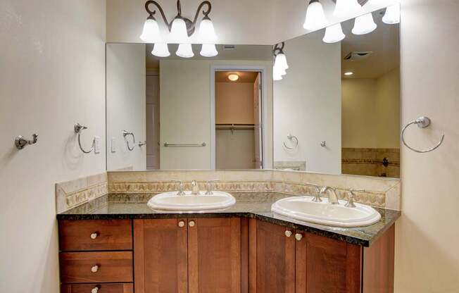 A bathroom with two sinks and a large mirror.